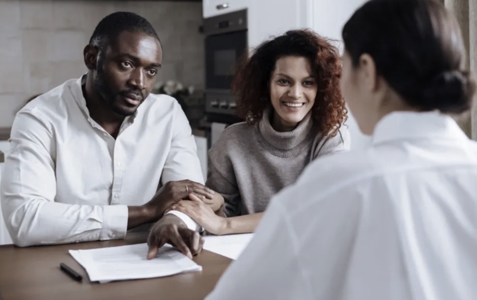 Couple at a table being explained a document by a consultant
